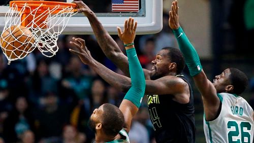 Dewayne Dedmon (14) of the Hawks dunks against the Celtics in Boston, Sunday, April 8, 2018. (AP Photo/Michael Dwyer)