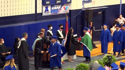 An image provided by Asheboro (North Carolina) City Schools shows Ever Lopez wearing a Mexican flag over his gown at his graduation ceremony on Thursday. The school district said on Friday afternoon that Lopez had not received his diploma because he had violated the school’s dress code and because he had “detracted from the importance and the solemnity of the ceremony.” He received the diploma Monday, according to reports.