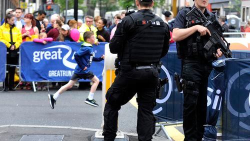 Armed police guard the area during the Great Manchester Run in Manchester, England Sunday, May 28, 2017. More than 20 people were killed in an explosion following a Ariana Grande concert at the Manchester Arena late Monday evening. (AP Photo/Rui Vieira)