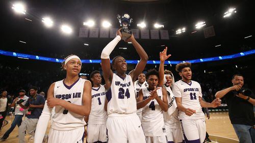 March 10, 2018 - Atlanta, Ga: Upson-Lee guard Tye Fagan (24) holds the state championship trophy up as he celebrates with teammates after their win against St. Pius during the GHSA Class AAAA Boys State Championship at McCamish Pavilion Saturday, March 10, 2018, in Atlanta. Upson-Lee won 70-54. PHOTO / JASON GETZ