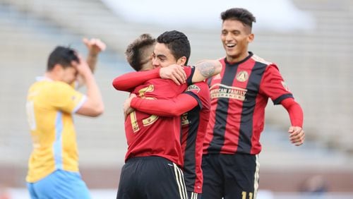 Miguel Almiron and Hector Villalba hug after a goal in the first half of Saturday’s preseason game in Chattanooga. (Miguel Martinez)