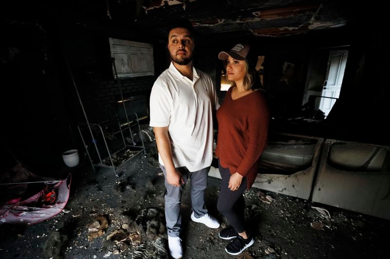 Antuan and Lexi Aguirre escaped a fire that started on the first floor of their Cherokee County home this month by crawling through a second-floor window to their roof, where neighbors helped rescue them. 