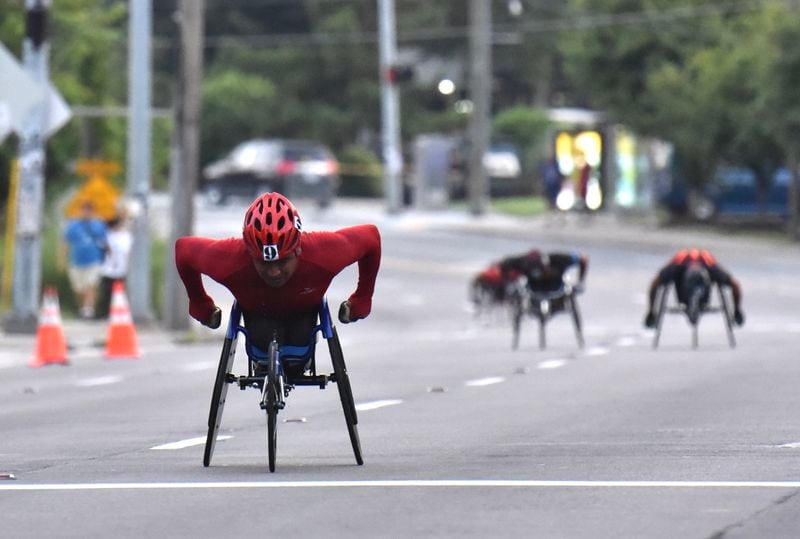 A wheelchair racer pushes through Cardiac Hill during the 2018 AJC Peachtree Road Race.