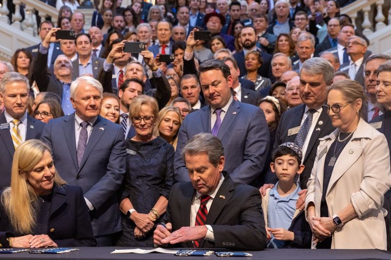 Gov. Brian Kemp signs into law House Bill 30, a measure that makes antisemitism part of the state's hate crimes statute. (Arvin Temkar / arvin.temkar@ajc.com)