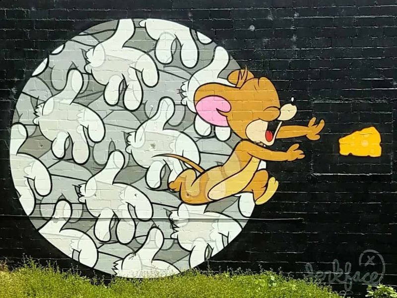 Jerry, the mischievous mouse from the Hannah-Barbera cartoon “Tom and Jerry,” chases a piece of cheese in this work by Jerkface. It’s at 1083 Euclid Ave. CONTRIBUTED: ART RUDICK