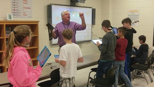 Cherokee County School District instructional technology specialist Jim Berry leads a lesson in the media center.