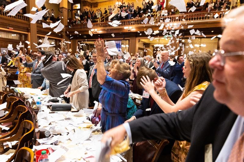 State representatives throw paper in the air to celebrate the end of the legislative session at the House of Representatives in the Capitol in Atlanta on Thursday.