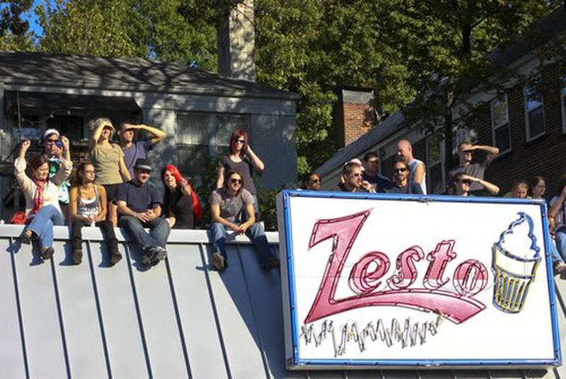 Some of the parade spectators climb the roof of Zesto's to get a better view of the 10th Annual Little Five Points Halloween Parade.