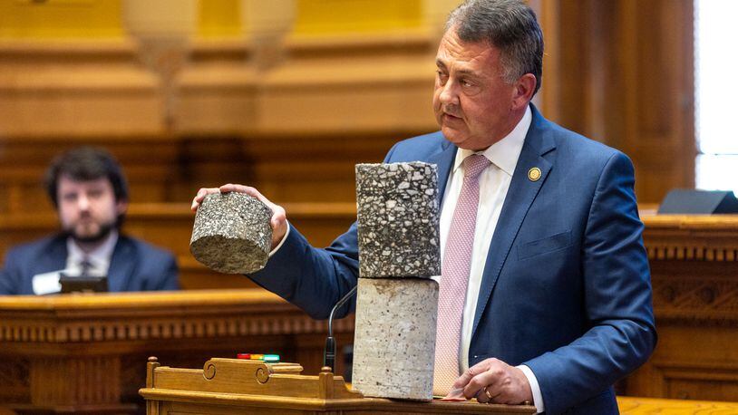 State Senate Majority Leader Steve Gooch, R-Dahlonega, holds a highway core sample while speaking in support of House Bill 189 in the state Senate on Thursday. The bill would temporarily allow some trucks to carry heavier loads on Georgia highways. (Arvin Temkar / arvin.temkar@ajc.com)