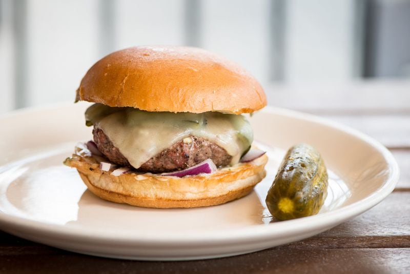 The Burger, with Big Green Egg-grilled grass-fed beef, roasted poblano pepper, melted chedder cheese, red onion, cilantro aioli, from the menu at Muss and Turner’s. MIA YAKEL