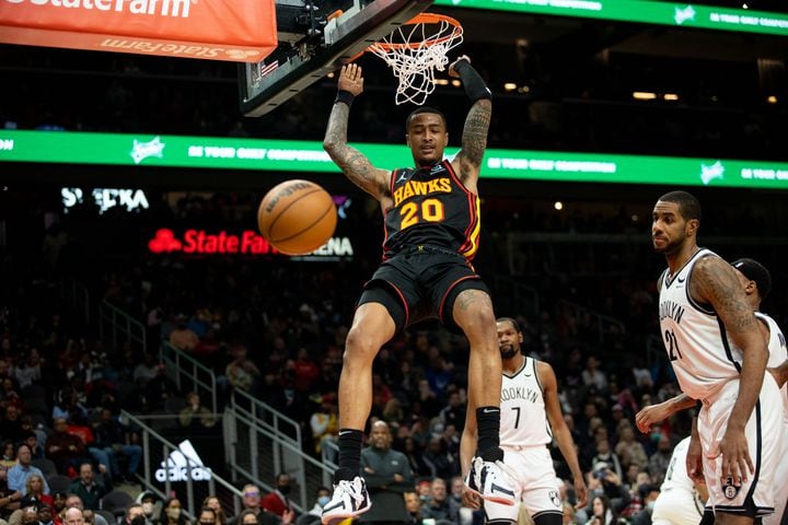 The Hawks' John Collins (20) dunks the ball during a game between the Atlanta Hawks and the Brooklyn Nets at State Farm Arena in Atlanta, GA., on Friday, December 10, 2021. (Photo/ Jenn Finch)