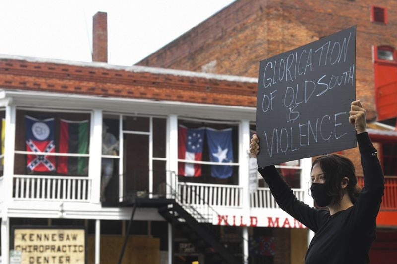 Chelsea Shag demonstrates across the street from a Confederate-era memorabilia shop, during a protest held June 5, 2020, in Kennesaw. Protests around the nation are occurring to sound off against the death of George Floyd in Minneapolis police custody. JOHN AMIS FOR THE ATLANTA JOURNAL-CONSTITUTION