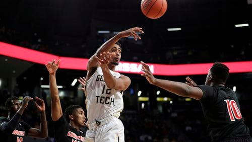 Georgia Tech's Quinton Stephens, center, passes the ball in the second half of an NCAA college basketball game against Louisville in Atlanta, Saturday, Jan. 7, 2017. (AP Photo/David Goldman)