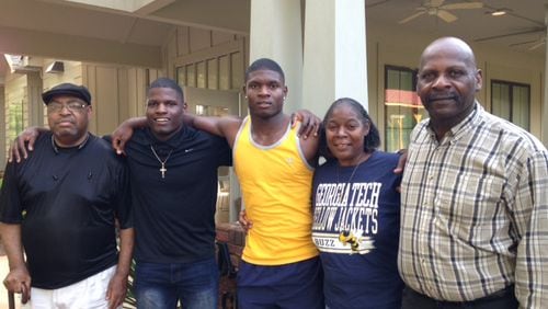 Georgia Tech signee Jaquan Henderson (yellow shirt) poses with his family in front of the Nelson Heights Community Center in Covington with, from left, his grandfather James Russell, his brother Anthony, his mother Sandy and his father J.C. (AJC photo by Ken Sugiura)