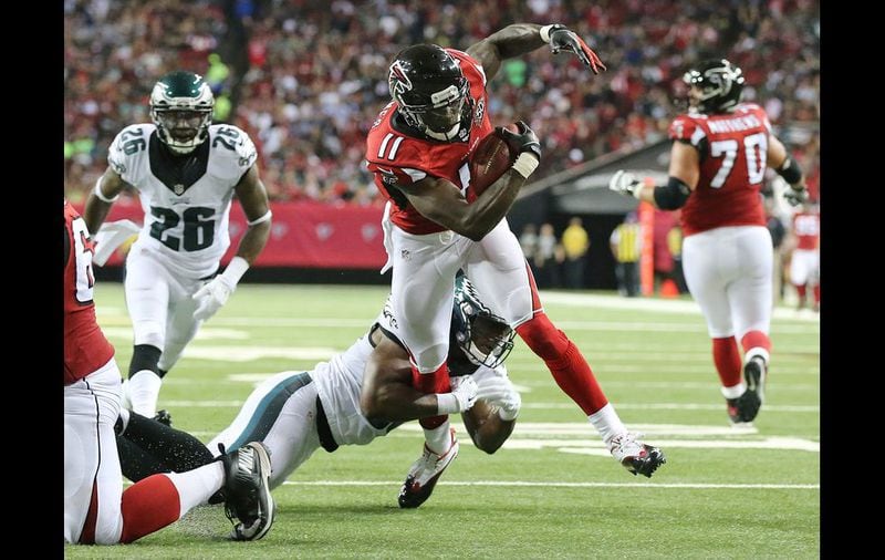 Falcons wide receiver Julio Jonescatches a pass and breaks a tackle attempt by Eagles linebacker DeMeco Ryans on his way to the endzone for a touchdown and a 10-0 lead during the second quarter in their Monday Night Football game on Monday, Sept. 14, 2015, in Atlanta. Curtis Compton / ccompton@ajc.com