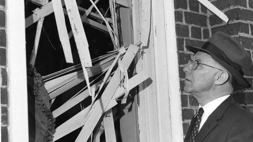 Mayor Hartsfield examines the damage done to a window as a result of the Hebrew Benevolent Congregation bombing in Atlanta, October 1958. What came to be known as the "Temple bombing" was an attack by white supremacists on the Temple, which had been a center for civil rights advocacy during the '50s. Nobody was injured in the blast.