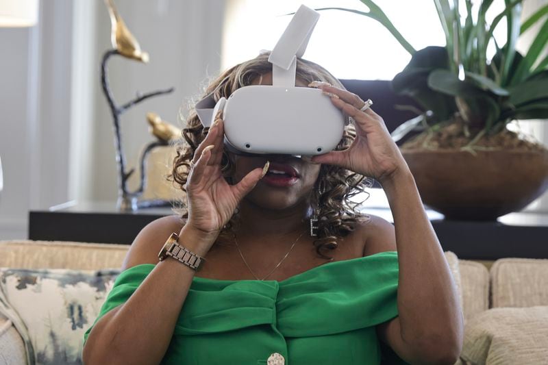 Stylist Evonya Easley views her fashion show  ‘Innovate and Create on virtual reality goggles on Tuesday, March 7, 2023. The 3D show will feature the clothing of Black women designers on March 18. (Natrice Miller/ Natrice.miller@ajc.com)