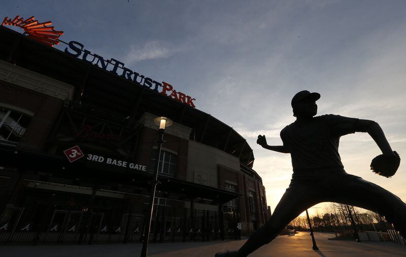 March 20, 2017, Atlanta: A statue of Braves Hall of Fame pitcher Phil Niekro, nicknamed Knucksie, is seen at sunset outside the third base gate at SunTrust Park the home ballpark for the Atlanta Braves on Monday, March 20, 2017, in Atlanta.   Curtis Compton/ccompton@ajc.com