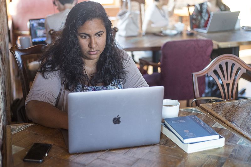 Sunita Theiss works on a monthly devotional for In Touch Ministries at Moonbird Coffee in Chamblee, Friday, September 27, 2019.  Sunita is a writer and content strategist for In Touch Ministries which is based in metro-Atlanta. (Alyssa Pointer/alyssa.pointer@ajc.com)