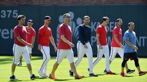 Braves pitchers walk on the field during a workout ahead of the National League Championship Series against the Los Angeles Dodgers at Truist Park on Friday, October 15, 2021. (Hyosub Shin / Hyosub.Shin@ajc.com)