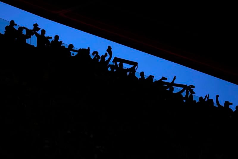 Fans cheer ahead the Champions League quarterfinal soccer match between Atletico Madrid and Borussia Dortmund at the Metropolitano stadium in Madrid, Spain, Wednesday, April 10, 2024. (AP Photo/Manu Fernandez)