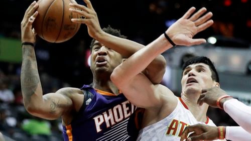 Phoenix Suns’ Marquese Chriss, left, grabs a rebound from Atlanta Hawks’ Ersan Ilyasova in the second quarter of an NBA basketball game in Atlanta, Tuesday, March 28, 2017. (AP Photo/David Goldman)