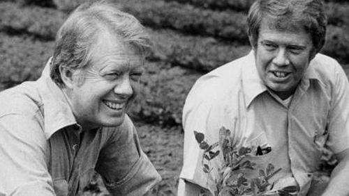 Jimmy Carter, left, and brother Billy talk in 1976 in their hometown of Plains, Ga.