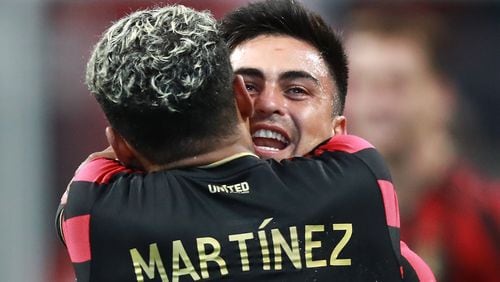 Atlanta United midfielder Pity Martinez (right), who scored the first goal of the game, gives forward Josef Martinez (left) a hug after his goal while celebrating their 2-0 victory over D.C. United in a soccer match on Sunday, July 21, 2019, in Atlanta.   Curtis Compton/ccompton@ajc.com