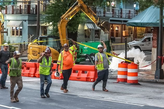 Crews work to repair a water line at 11th Street and Peachtree Street in Midtown on Monday morning. 