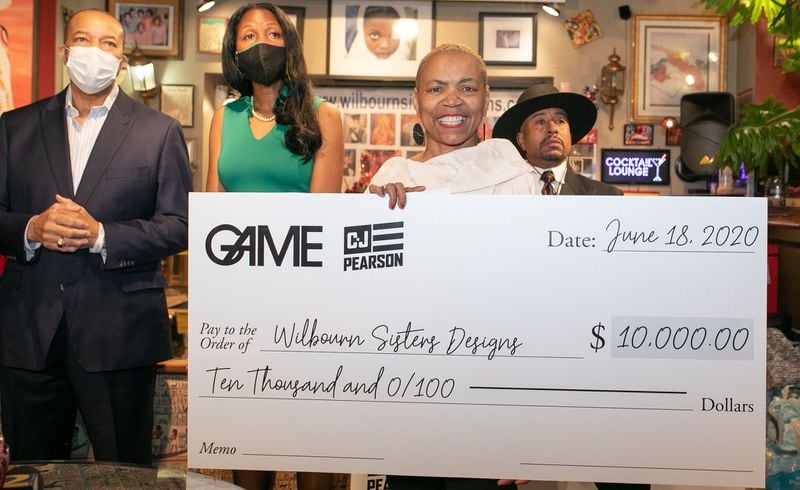 Janice Wilbourn accepts a $10,000 donation from the GAME Relief Fund. CONTRIBUTED