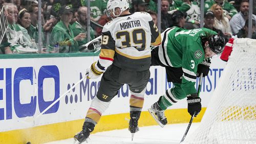 Vegas Golden Knights right wing Anthony Mantha (39) and Dallas Stars defenseman Chris Tanev (3) compete for possession of the puck during the second period in Game 2 of an NHL hockey Stanley Cup first-round playoff series in Dallas, Wednesday, April 24, 2024. (AP Photo/Tony Gutierrez)
