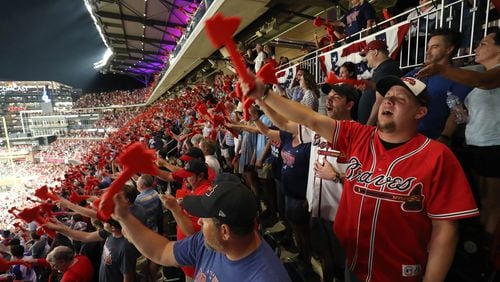 Braves fans participate in the tomahawk chop at a 2018 playoff game at SunTrust Park (now Truist Park). (Photo by Jason Getz/Special to the AJC)
