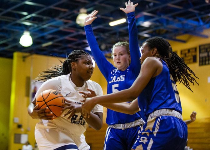 Adrieanna Browniee (left), center for South Dekalb High School, drives past Haley Johnson (middle), guard for Cass High School, and Londaisha Smith (right), wing for Cass High School during the South Dekalb vs. Cass girls basketball playoff game on Friday, February 26, 2021, at South Dekalb High School in Decatur, Georgia. South Dekalb defeated Cass 72-46. CHRISTINA MATACOTTA FOR THE ATLANTA JOURNAL-CONSTITUTION