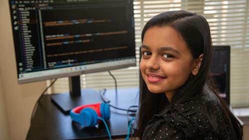 Portrait of Aesha Bhatt at her computer where she taught herself coding in her Johns Creek home. While we've heard a lot of news about kids who lost a year of learning by not being in school, 11-year-old Aesha Bhatt of Johns Creek proves just the opposite, because she's been incredibly creative and productive throughout the pandemic, exploring coding and app development. When the pandemic started, her father Mehul Bhatt wanted his daughter to stay creative and engaged in learning, and while he knew she liked tech, he wasn't sure if coding was right at her age. She took to it immediately. The sixth grader created an anti-bullying app and is helping her mother Hita Bhatt develop a YouTube cooking channel. Aesha designed the channel's website and logo and edits its pages.
PHIL SKINNER FOR THE ATLANTA JOURNAL-CONSTITUTION.