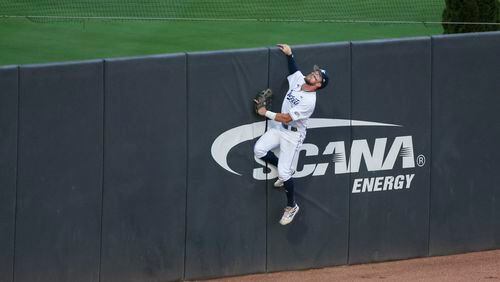 Georgia Tech outfielder Trey Yunger (18) leaps up the left field fence but cannot get to a solo home run hit by Auburn infielder Cooper Weiss (not pictured) during the fifth inning at Russ Chandler Stadium, Tuesday, May 7, 2024, in Atlanta. (Jason Getz / AJC)
