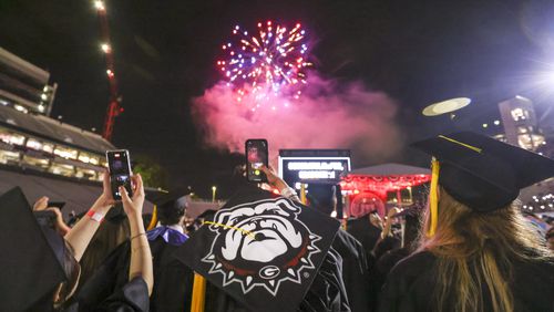 A fireworks display is shown as University of Georgia students react during the closing ceremony of the Spring Undergraduate Commencement at Sanford Stadium, Friday, May 12, 2023, in Athens, Ga. (Jason Getz / Jason.Getz@ajc.com)