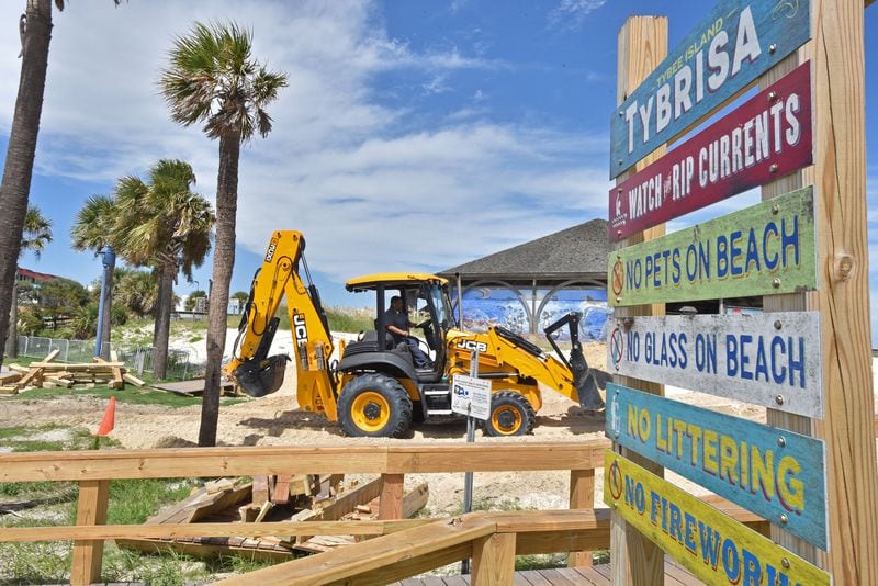 A worker builds a dune on Tybee Island ahead of Hurricane Dorian Tuesday. 