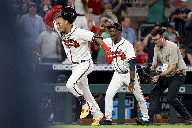 Braves designated hitter Orlando Arcia celebrates with third base coach Ron Washington after Arcia hit a two-run home run for a walk-off win 5-3 against the Boston Red Sox in the ninth inning at Truist Park on Wednesday, May 11, 2022, in Atlanta. (Jason Getz / Jason.Getz@ajc.com)