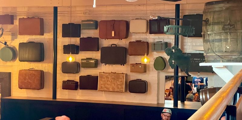 Suitcases hang on the wall at the Porter Beer Bar in Atlanta's Little Five Points neighborhood. / Courtesy of Angela Hansberger