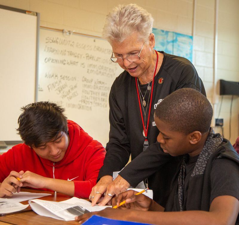Osborne High School teacher Annette Hansard (center) helps Eric Torres(left) and Kevin McCree with an assignment on Friday, Sept. 20, 2019. She recently celebrated her 50th year of teaching social studies in the Cobb County School District. She has been at Osborne the entire time and is the department chair of the school’s social studies department. PHIL SKINNER