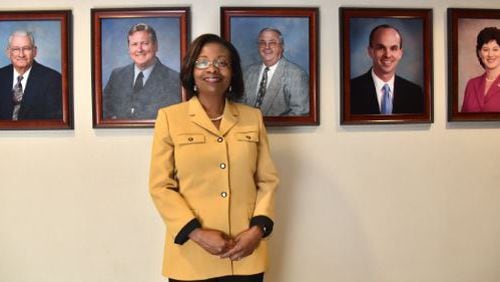 Portrait of newly elected Henry County Commission Chair June Wood in front of photographs of previous chairs of the Board of Commissioners. HYOSUB SHIN / HSHIN@AJC.COM