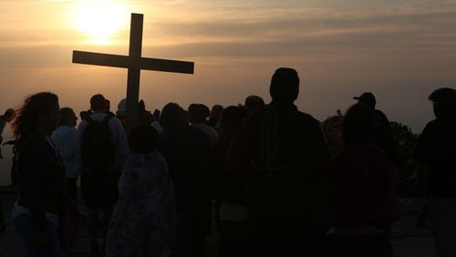 April 16, 2017, Atlanta, Georgia - Visitors gather around the cross at the top of the mountain after the Easter Sunrise Service at Stone Mountain Park in Stone Mountain, Georgia, on April 16, 2017. (HENRY TAYLOR / HENRY.TAYLOR@AJC.COM)