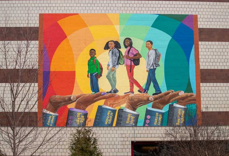 This mural, titled "Helping Hands," on a wall of the Atlanta University Center's Woodruff Library depicts four children walking to school with the "helping hands"of civil rights legends such as the Rev. Dr. Martin Luther King Jr. and Congressman John Lewis. PHOTO CONTRIBUTED.