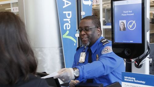 At the security check point at Hartsfield-Jackson's international terminal, TSA employee Phillip Oree clears a passenger who used facial recognition for screening. BOB ANDRES / BANDRES@AJC.COM