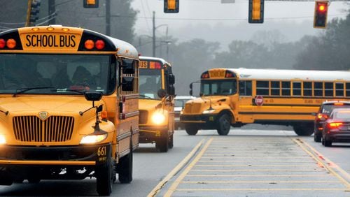With nearly a dozen school systems starting back on Thursday, the Georgia Department of Transportation urges drivers to exercise caution and maintain a 10-foot buffer around school buses. AJC file photo