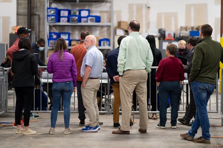 Observers watch as Fulton County elections workers process incoming ballots at the Fulton County Election Preparation Center after polls closed Tuesday, Dec. 6, 2022.  Ben Gray for the Atlanta Journal-Constitution