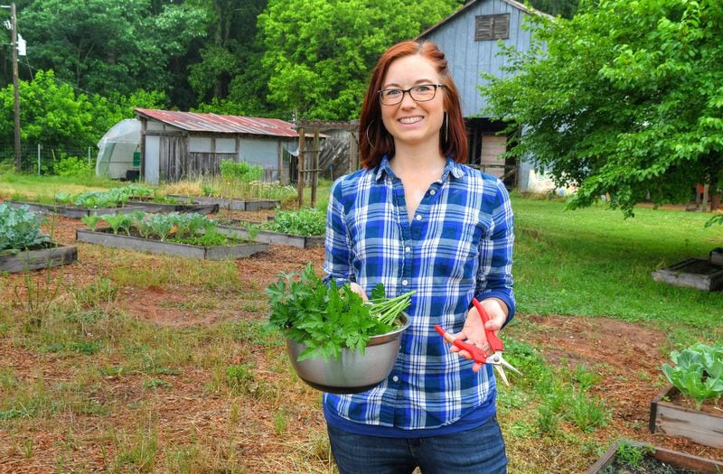 Noelle Joy, herb garden manager at UGArden in Athens, poses with a bowl of freshly harvested parsley from the parsley patch. CONTRIBUTED BY CHRIS HUNT PHOTOGRAPHY