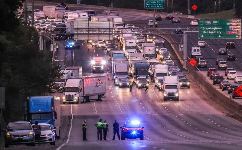 All lanes of I-285 East were held before New Northside Drive after a tractor-trailer carrying 89 cows overturned on the ramp to I-75. JOHN SPINK / JSPINK@AJC.COM