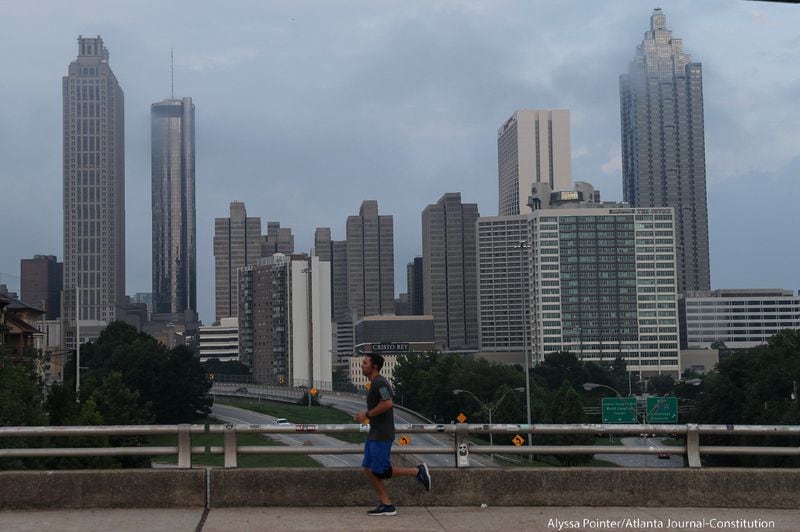 A jogger exercises along the Jackson Street Bridge during a muggy Monday morning in Atlanta.