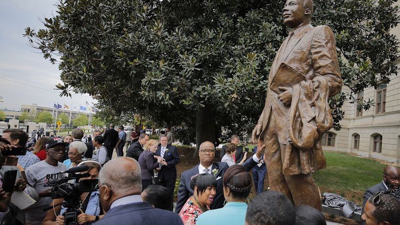 Rep. Calvin Smyre (hand on statue) played a role in getting a statue of the Rev. Martin Luther King Jr. placed on the grounds of the State Capitol. The statue was unveiled this summer on the anniversary of King’s famed “I Have a Dream” speech. BOB ANDRES /BANDRES@AJC.COM